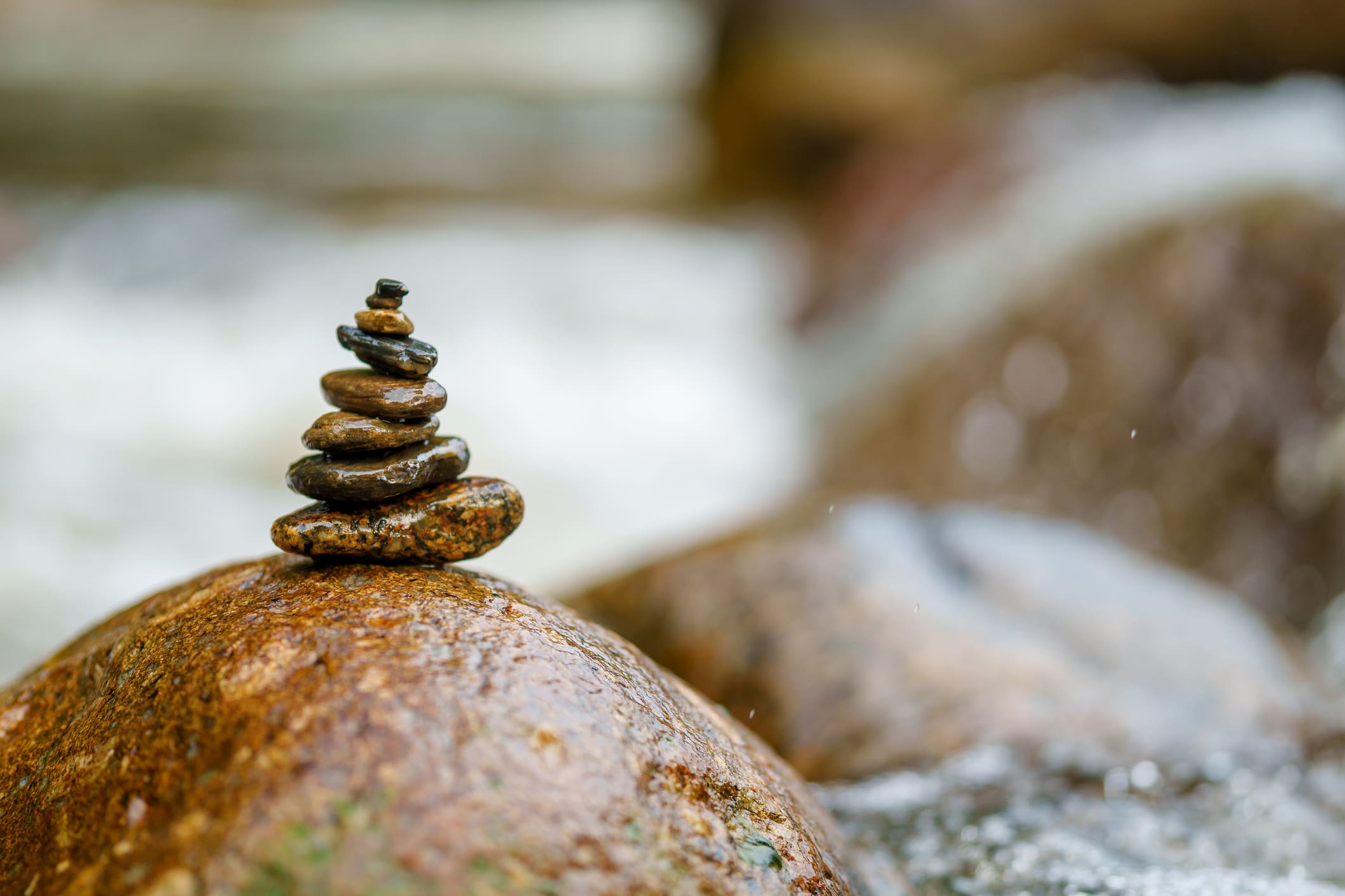 Stacked stones on a river rock.